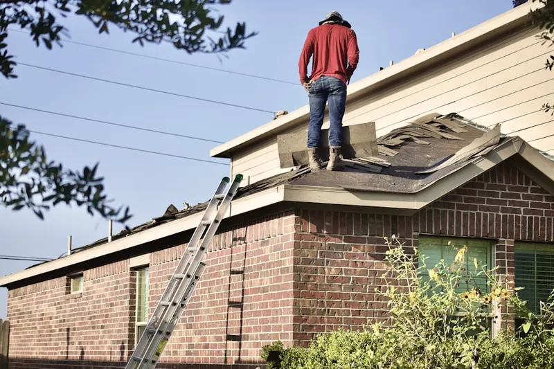 Professional roofer working on a residential roof in Levelland